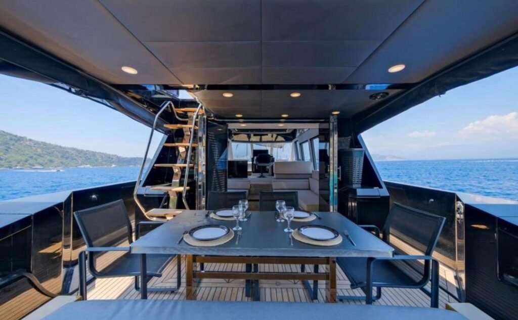 Mazu 58 charter Göcek — shaded aft deck dining table set for guests