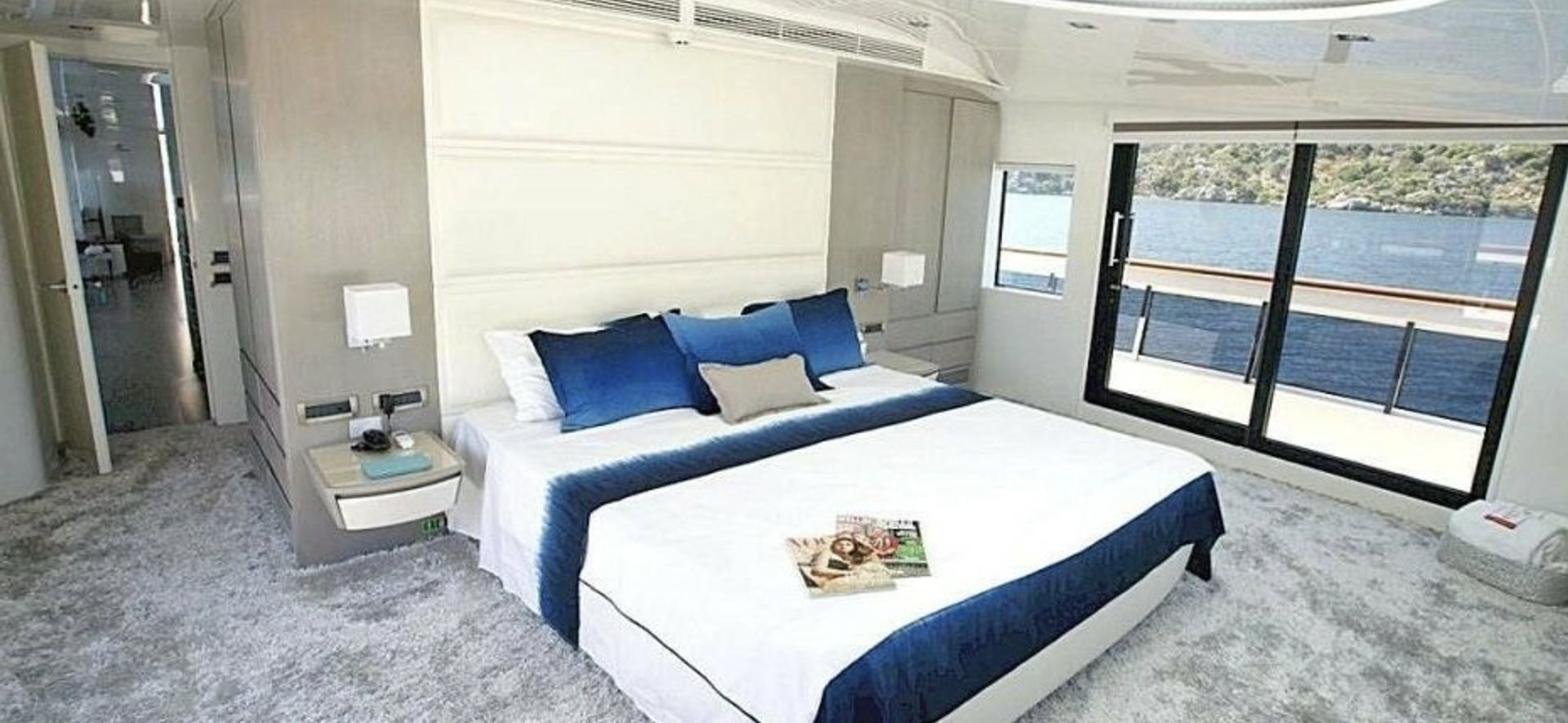 Mengi Yay 110 charter Göcek — full-beam master cabin with sea view