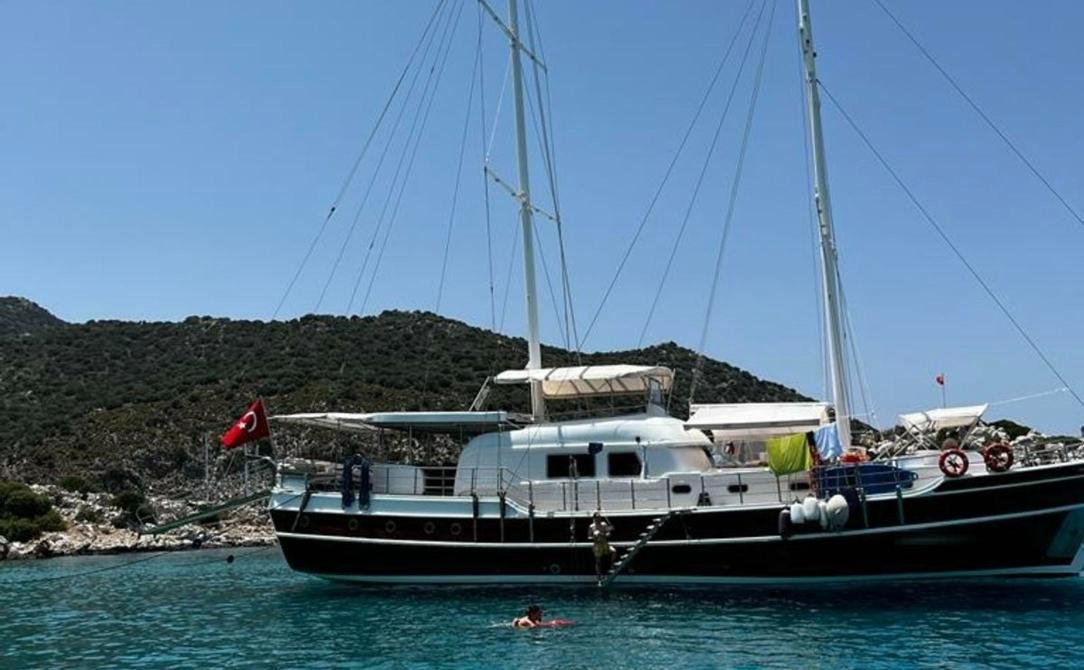 Modern gulet charter Bozburun - gulet at anchor with guests swimming