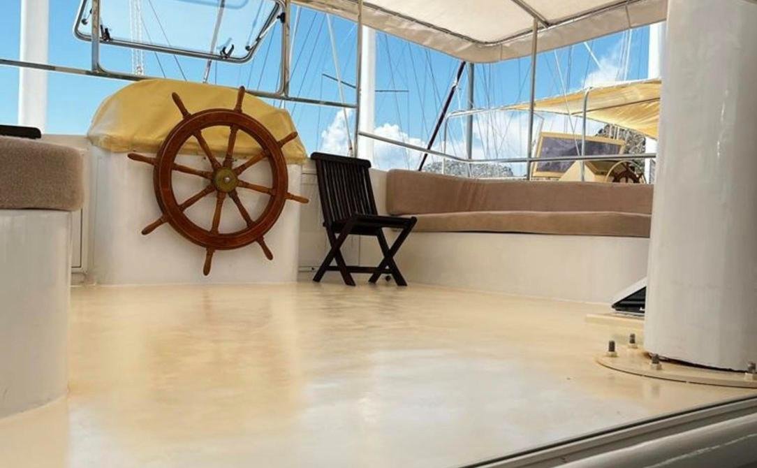 Modern gulet charter Bozburun - flybridge lounge with a timber ships wheel
