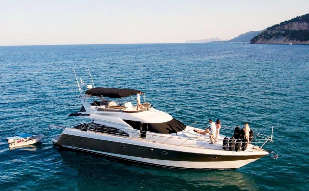 Guests on the foredeck of the Antalya motor yacht charter with the tender alongside