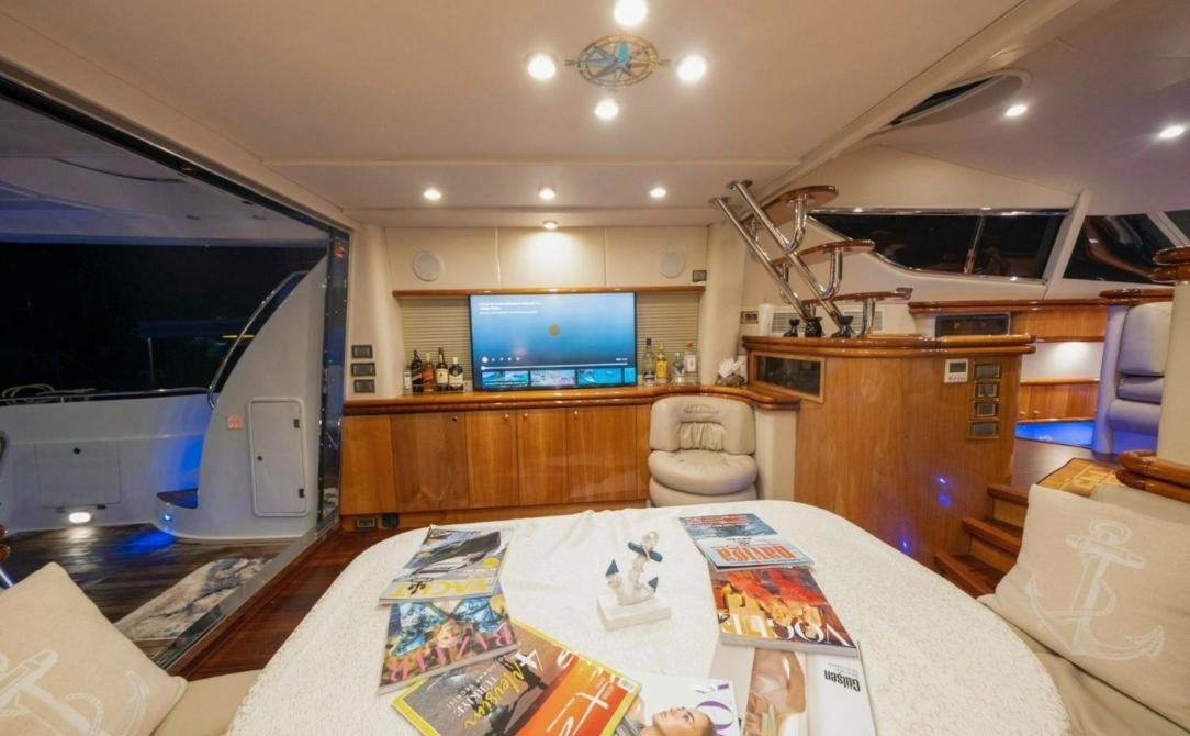 Saloon of the motor yacht charter Antalya looking aft to the cockpit doors at night