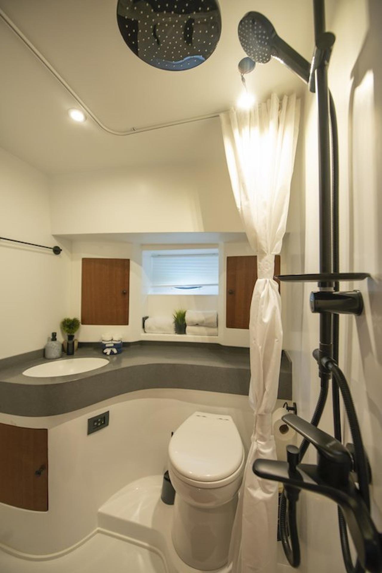 En-suite bathroom with rainfall shower and vanity aboard a luxury motor yacht