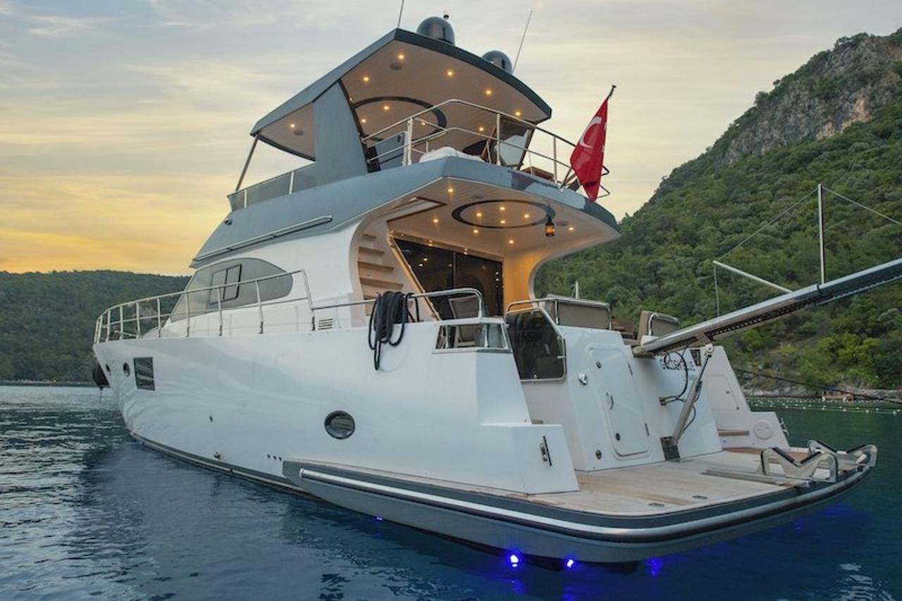 Stern view of a flybridge motor yacht at sunset near Fethiye, Turkey