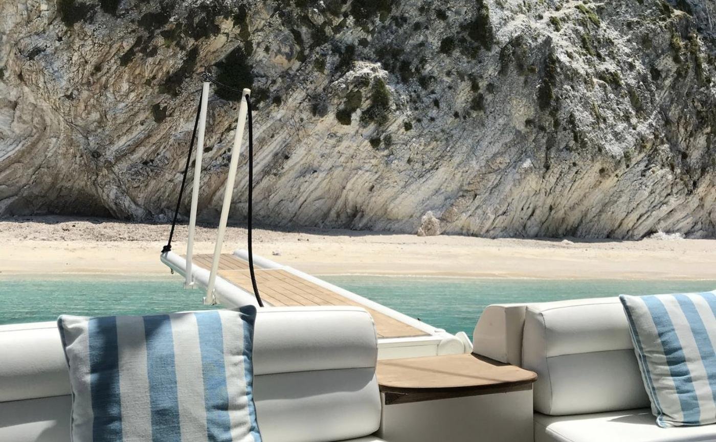 Cockpit seating with the passerelle run out to a beach on the motor yacht charter Paros