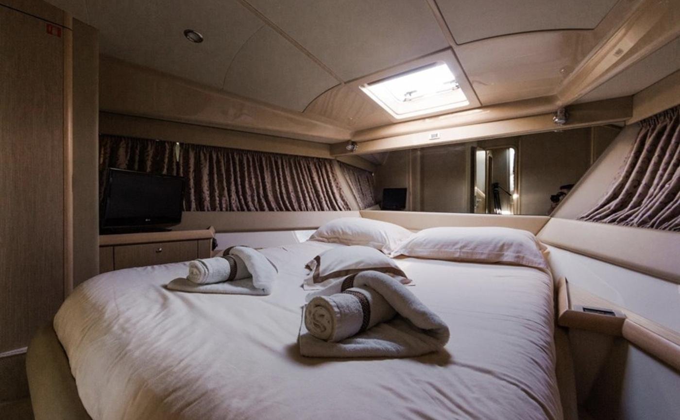 VIP cabin with island double berth and deck hatch on the motor yacht charter Paros