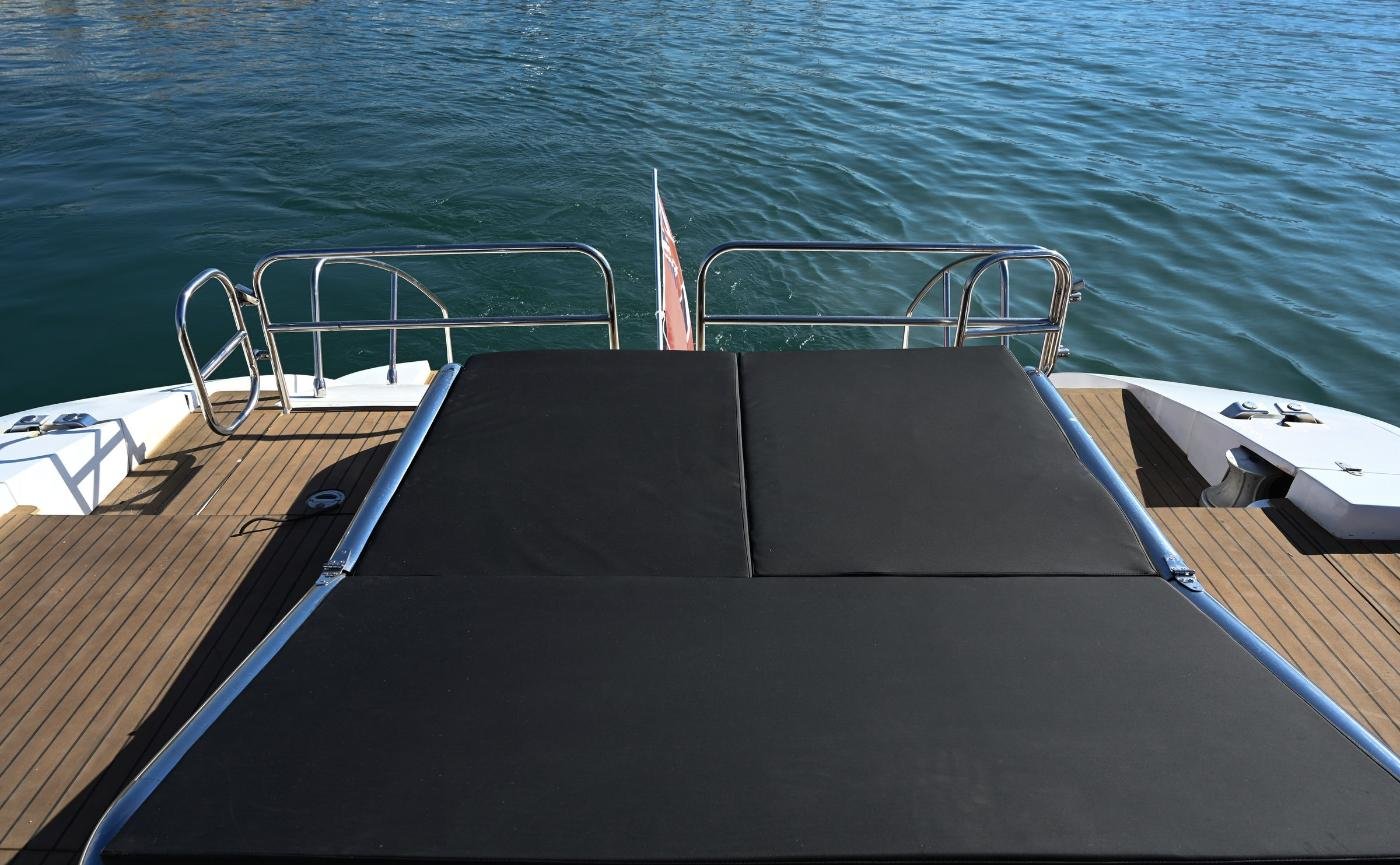 Aft sun pad over the bathing platform on a motor yacht charter Sicily