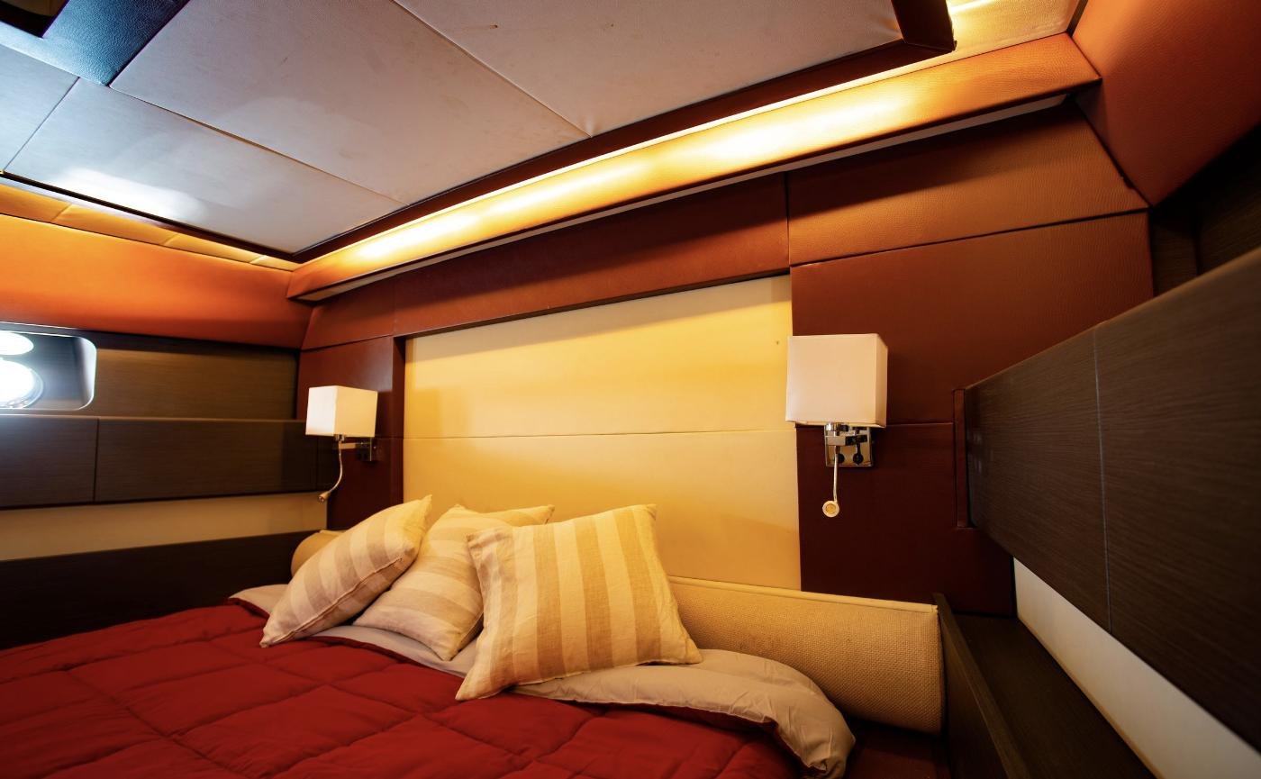 Master cabin with leather panelling and cove lighting on a motor yacht charter Sicily