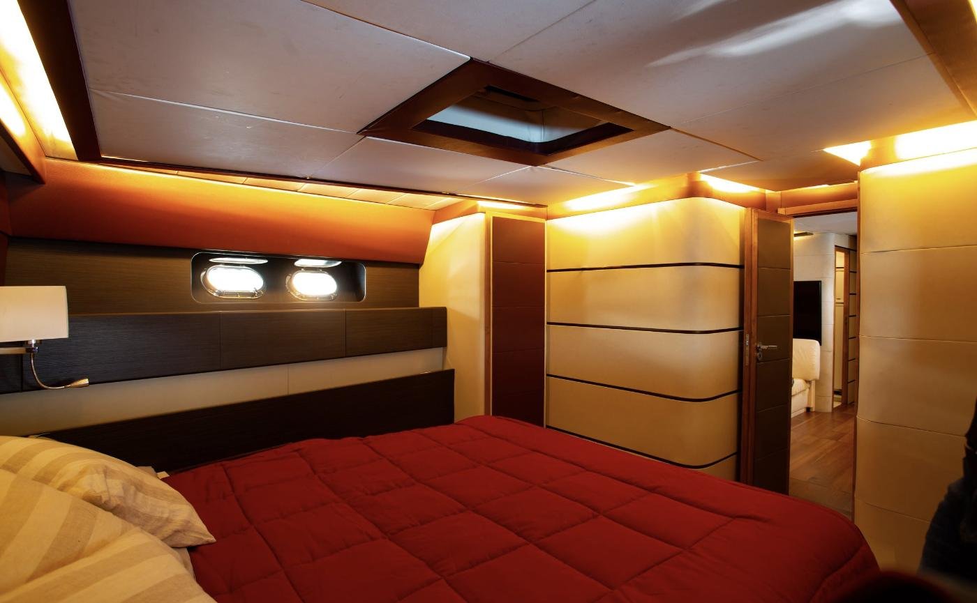 VIP cabin with overhead hatch and twin portlights aboard a 23m motor yacht