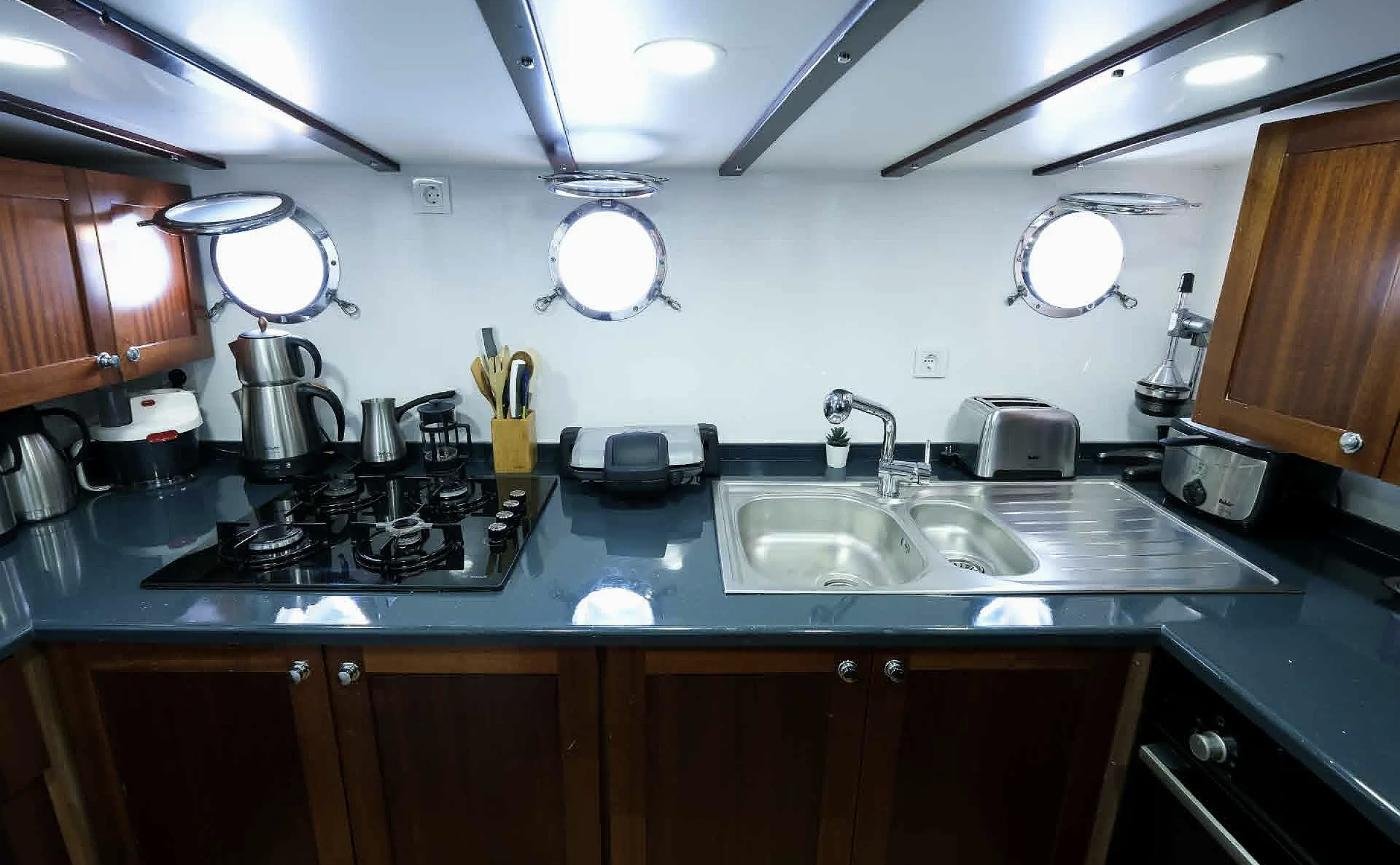 Crew galley with gas hob and twin sink on a premium gulet charter Fethiye