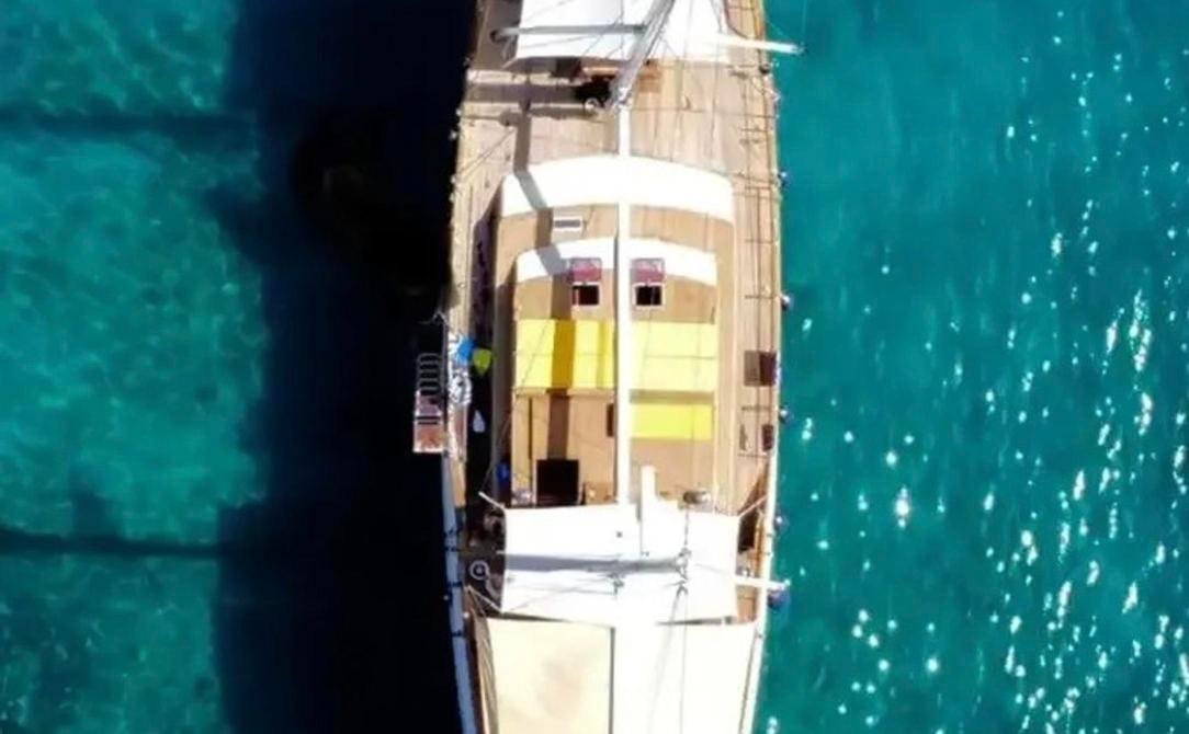 Romantic gulet charter Bodrum - overhead drone view of the 24m gulet in clear water