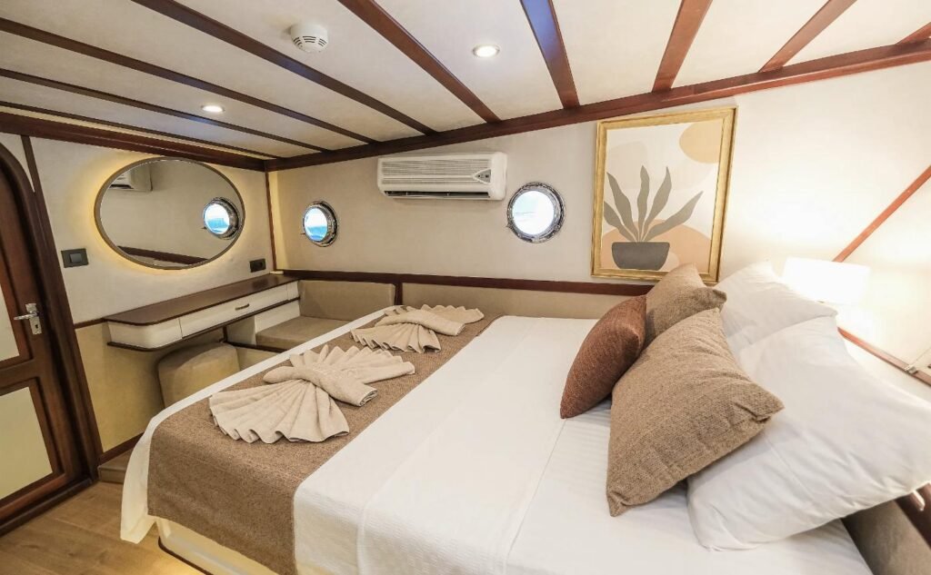 Master cabin with oval mirror and dressing console aboard a 36m Fethiye gulet