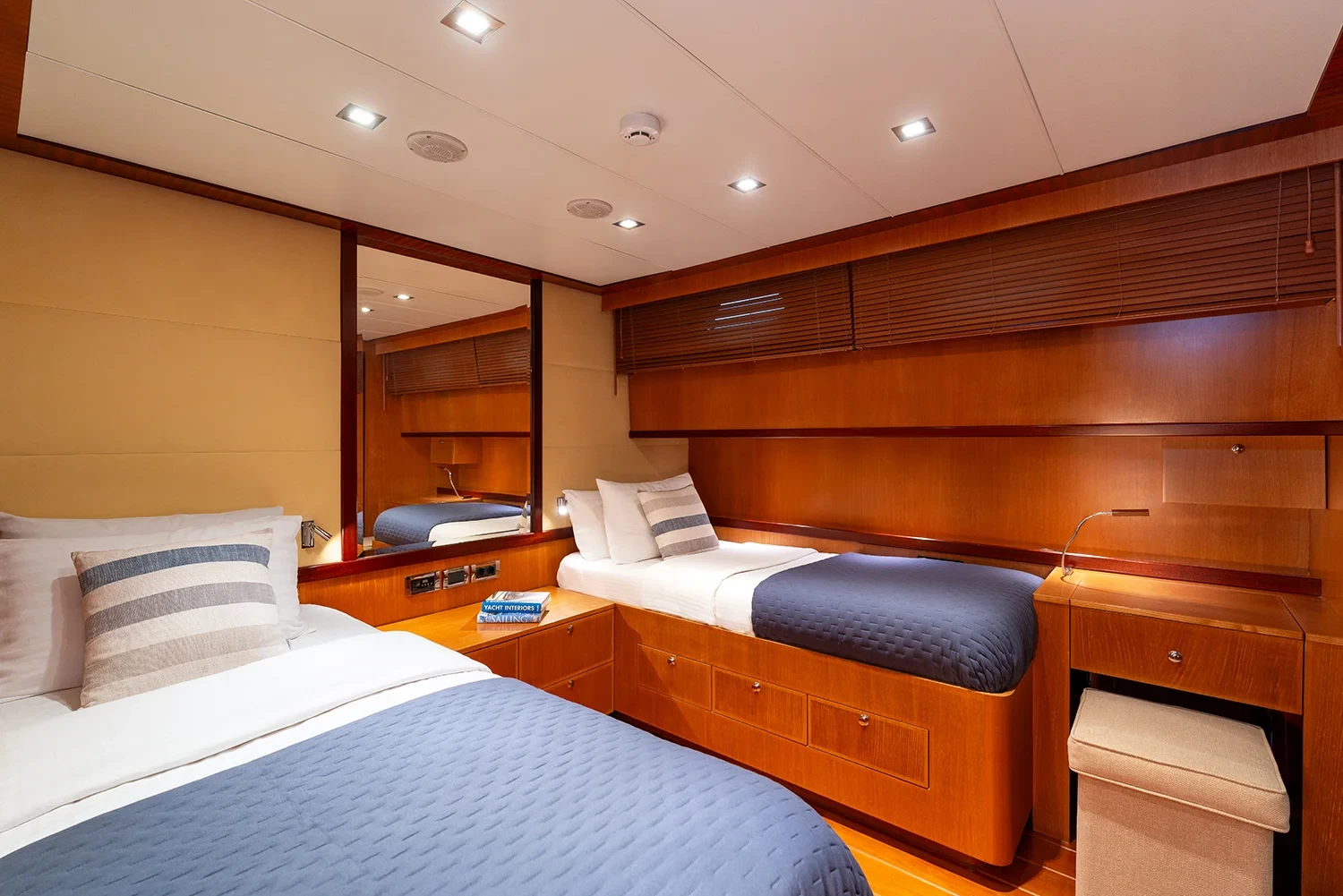 Twin cabin aboard a sailing yacht charter in Bodrum with two single berths and mirrored headboard