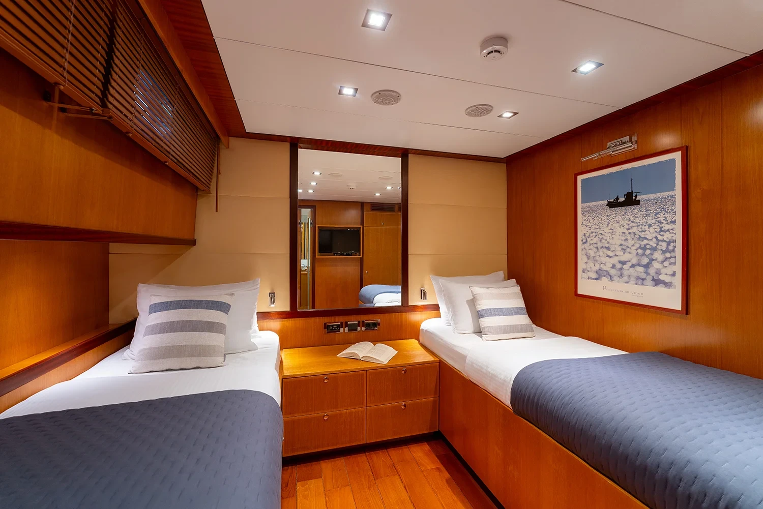 Second twin cabin aboard a sailing yacht charter in Bodrum with two single berths and framed artwork