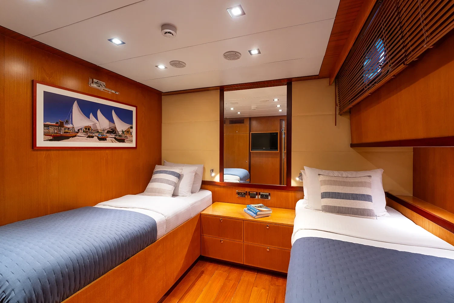 Second angle of the second twin cabin aboard a sailing yacht charter in Bodrum with a dhow print above the beds