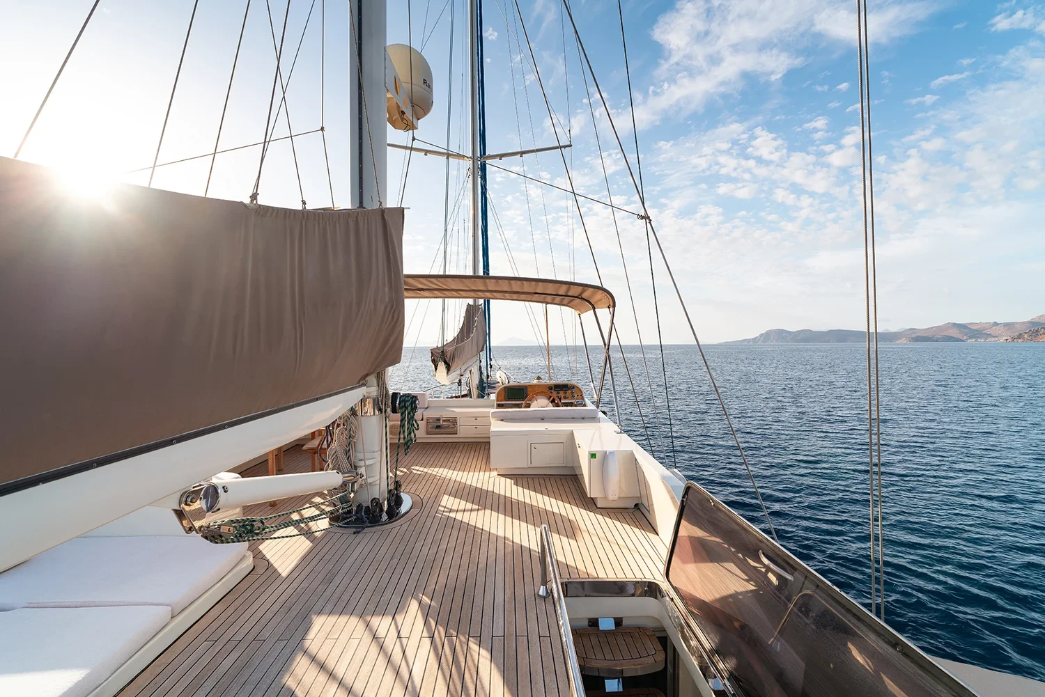 Sailing yacht charter Bodrum underway, view along the teak foredeck toward open water