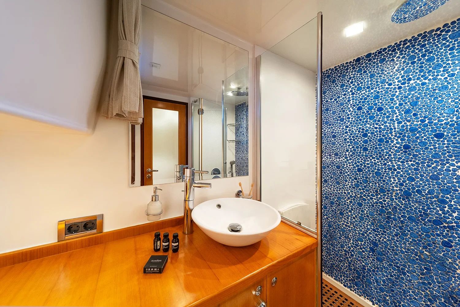 En-suite bathroom of the VIP double cabin aboard a sailing yacht charter in Bodrum with a stone vessel basin