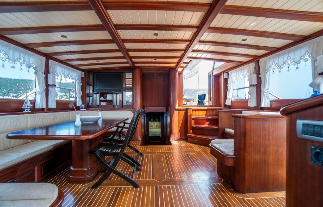 Main saloon with dining table aboard a 24m Turkish gulet