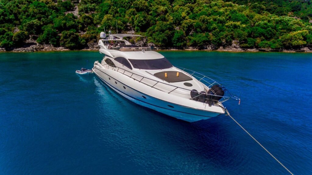 Sunseeker 74 charter - Sunseeker Manhattan 74 charter yacht at anchor in a turquoise bay near Göcek, elevated starboard view