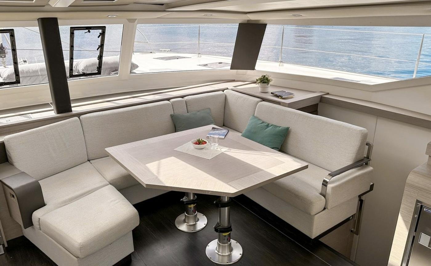 Tanna 47 charter Marmaris - saloon settee and dining table under panoramic windows