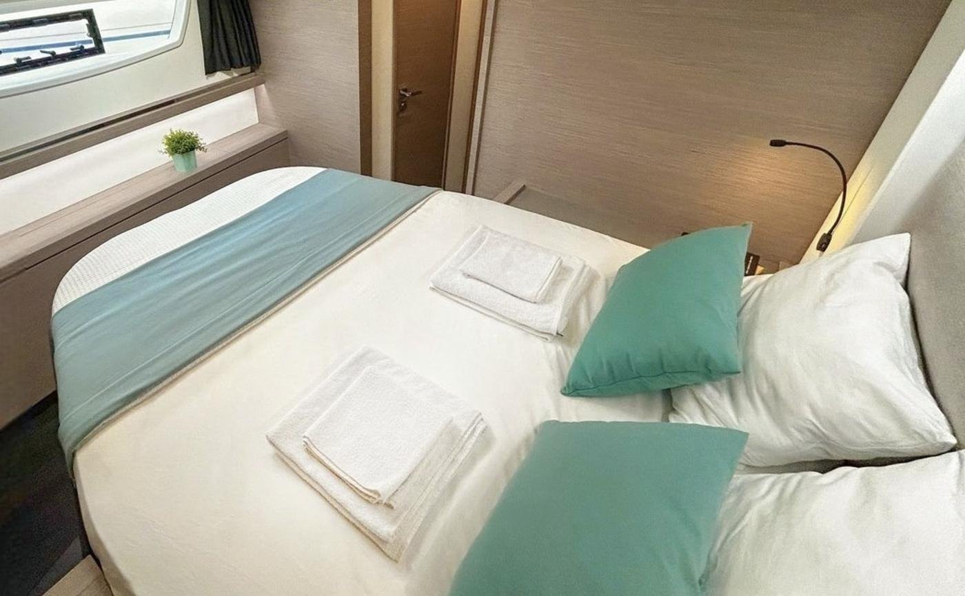 Tanna 47 charter Marmaris - guest double cabin with fresh linen and a hull window