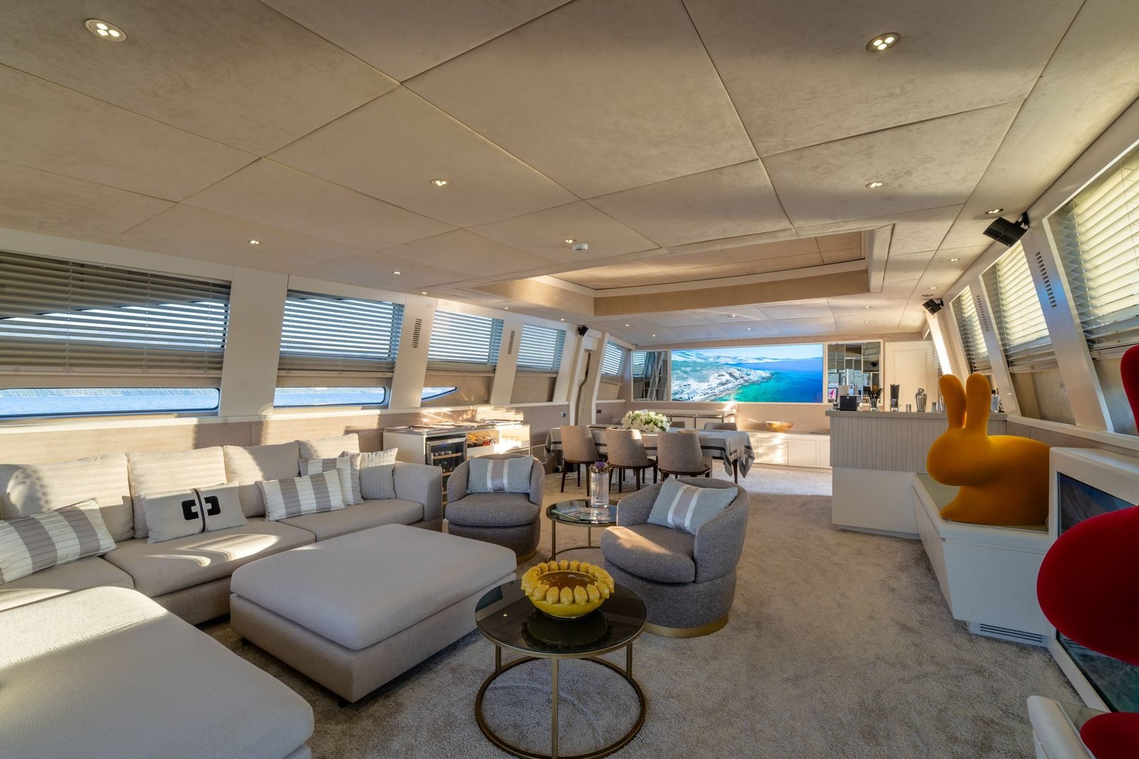 Main saloon of a Tecnomar 116 charter Bodrum with pale seating and panoramic windows