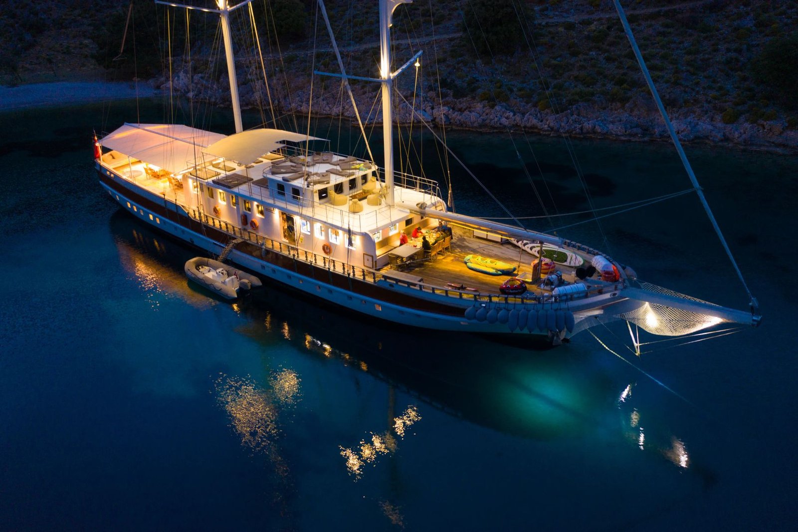 Large group gulet charter Fethiye aerial drone view at dusk anchorage