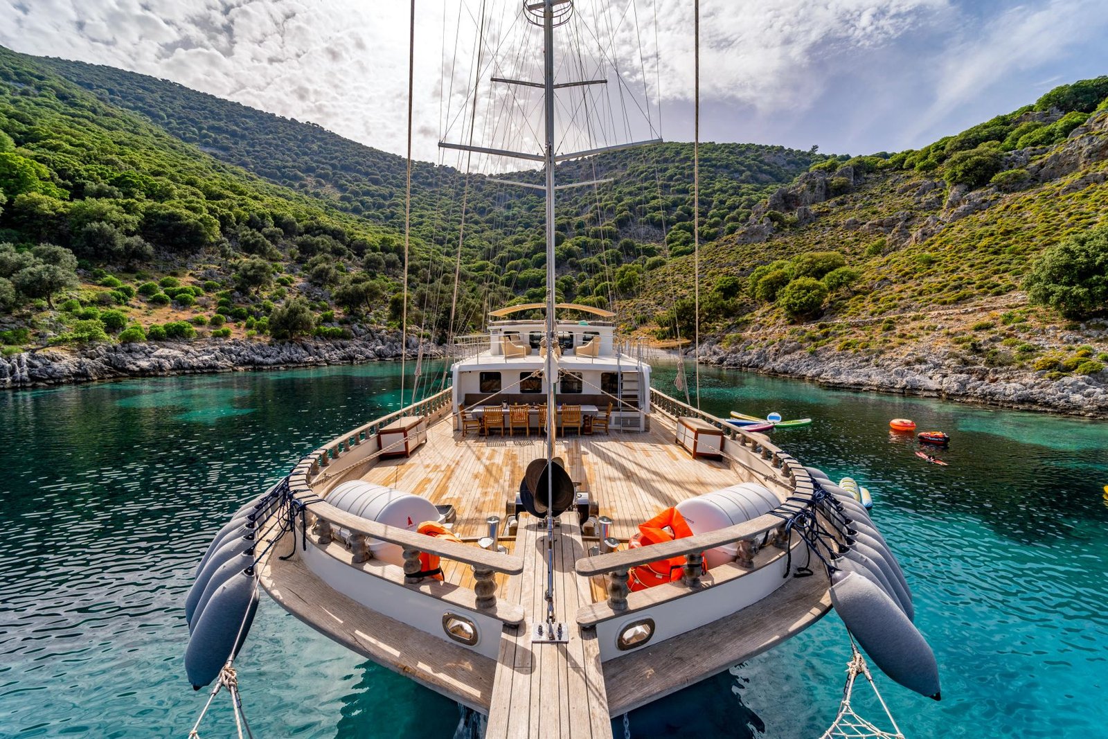 Group gulet charter Fethiye bow view with paddleboards at cove