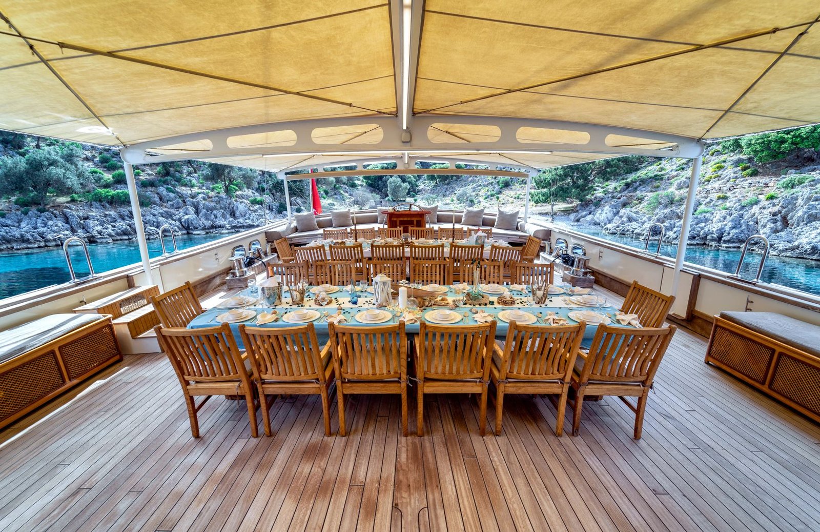 Covered aft deck dining table aboard group gulet charter Fethiye