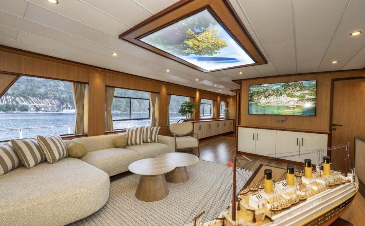 Main saloon with panoramic windows and cream sofas