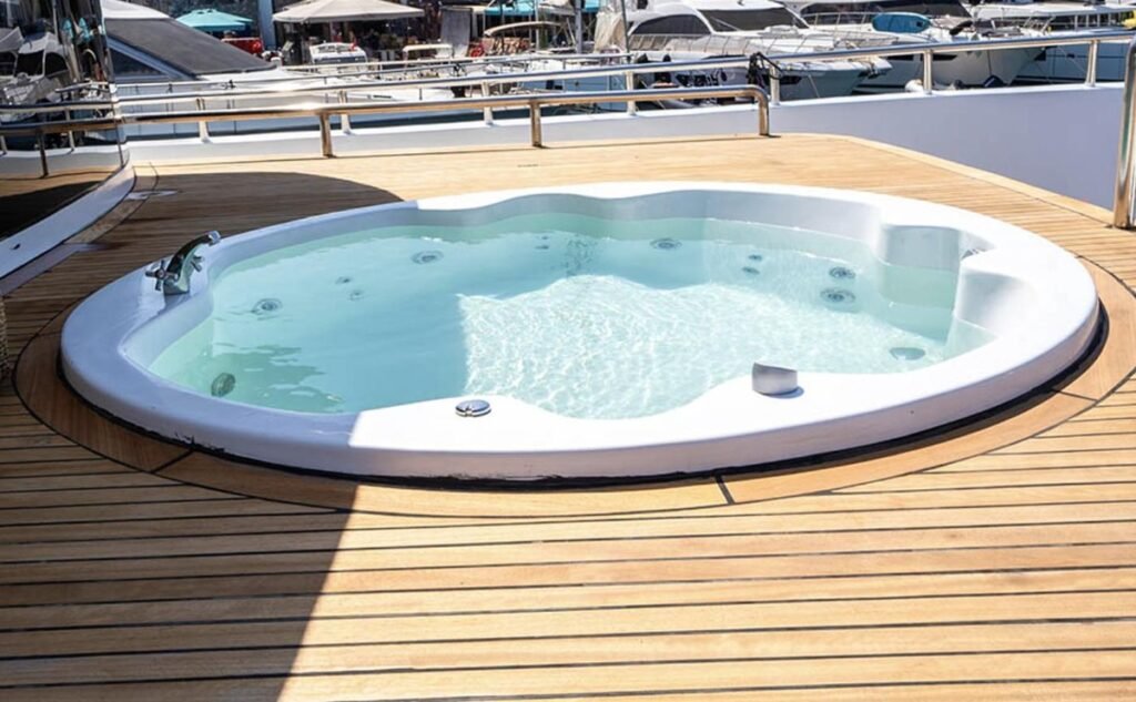 Teak sun deck jacuzzi overlooking Marmaris marina aboard a 26m trawler yacht