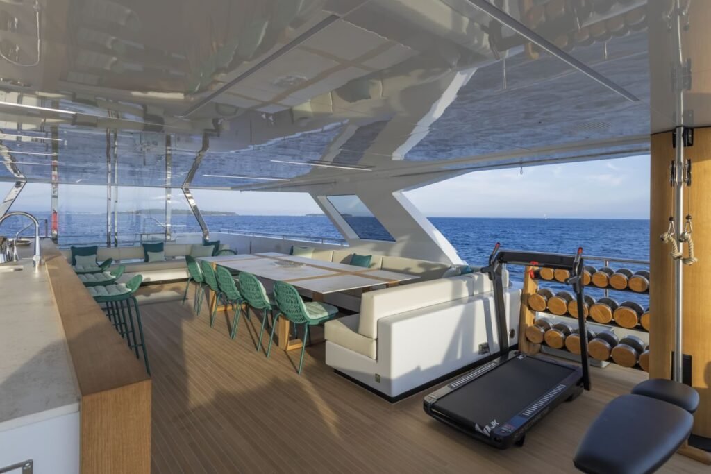 Sun deck with dining table, bar and jacuzzi on the 38m superyacht
