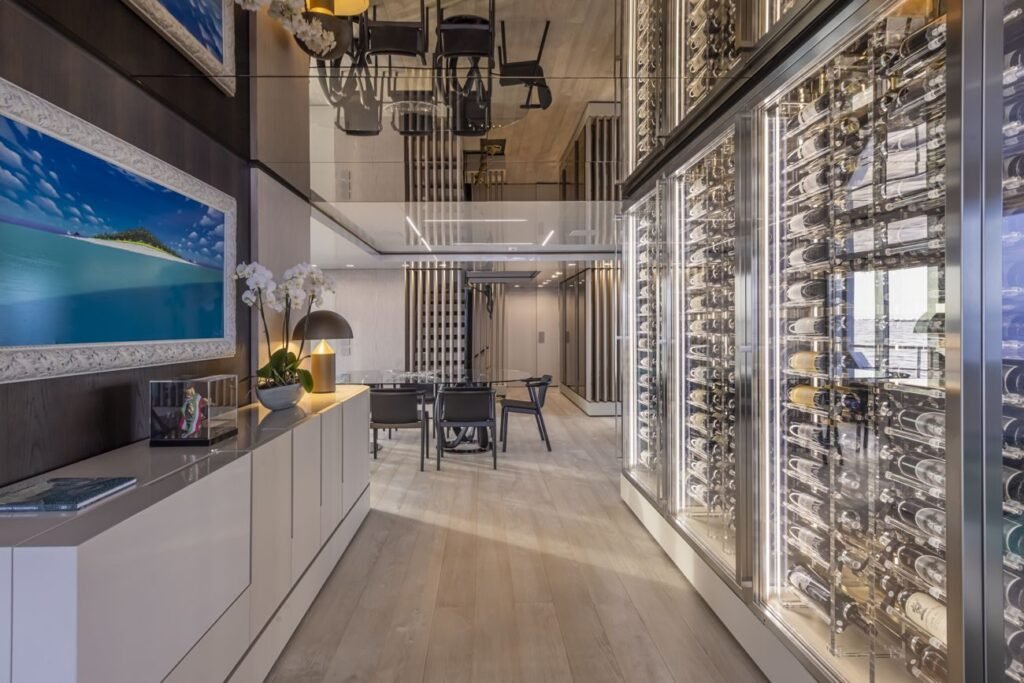 Main saloon with pale oak floors and full-height glazing on the 38m superyacht