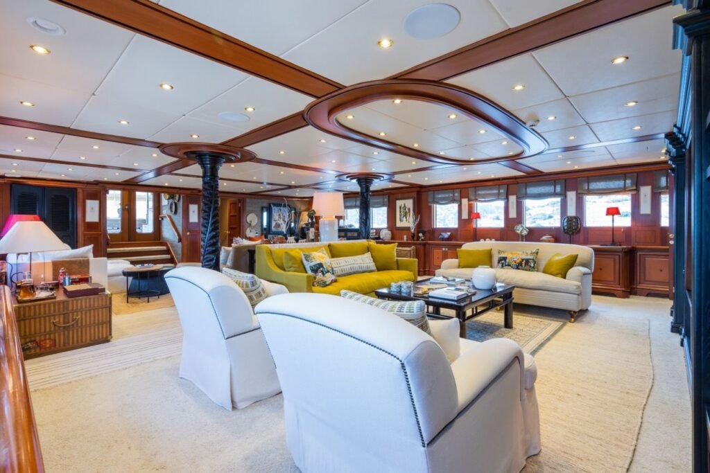 Main saloon with dark timber panelling and classic joinery on the 56m yacht
