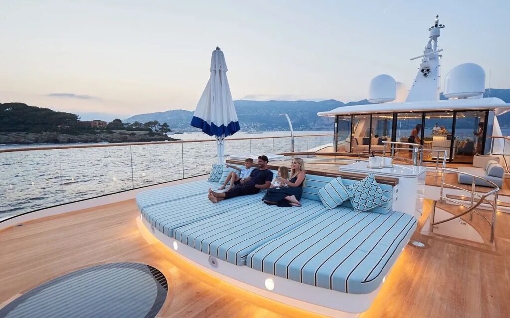 Foredeck sunpads and sun umbrella at golden hour aboard the 73m superyacht