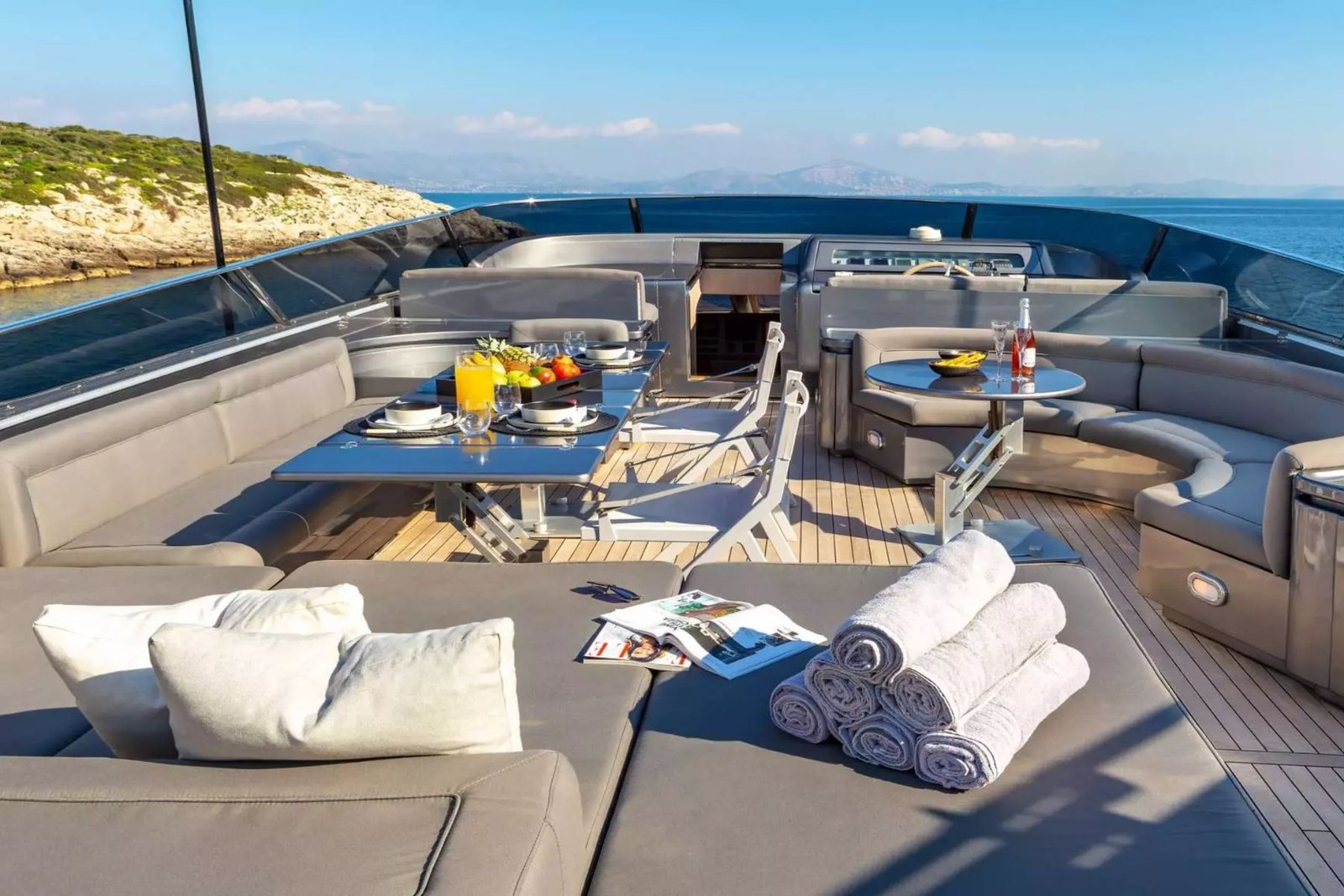 Atina kiralık Admiral 101 motoryatta kavisli kanepe ve şezlonglu flybridge oturma alanı