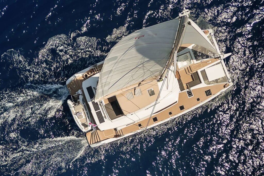 Alegria 67 charter Ibiza – aerial of the Fountaine Pajot catamaran under sail