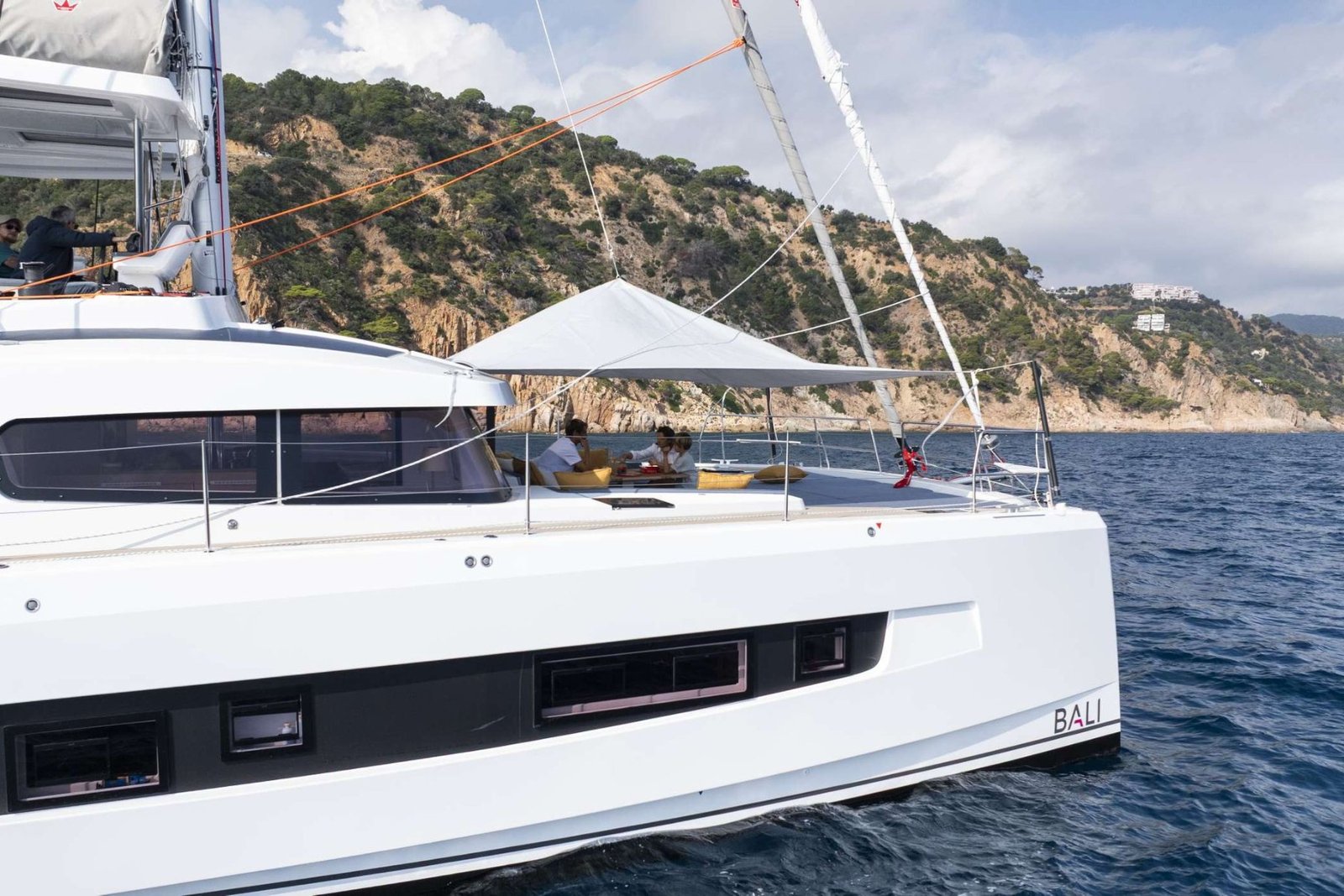 Bali 5.2 charter Ibiza catamaran bow quarter view alongside