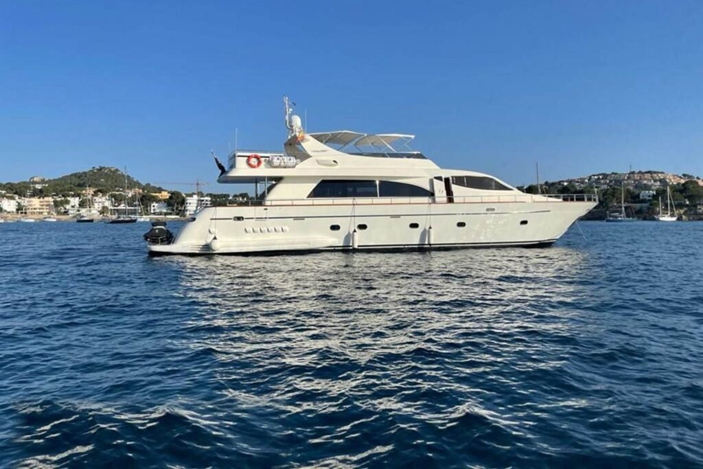 Falcon 86 luxury motor yacht full exterior profile at anchor in a Mediterranean bay on a crewed charter