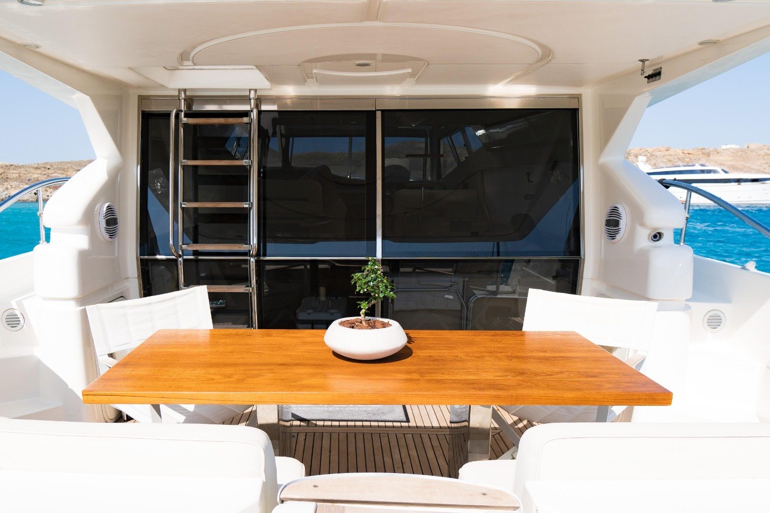 Aft deck dining table on a Ferretti 53 motor yacht charter Mykonos
