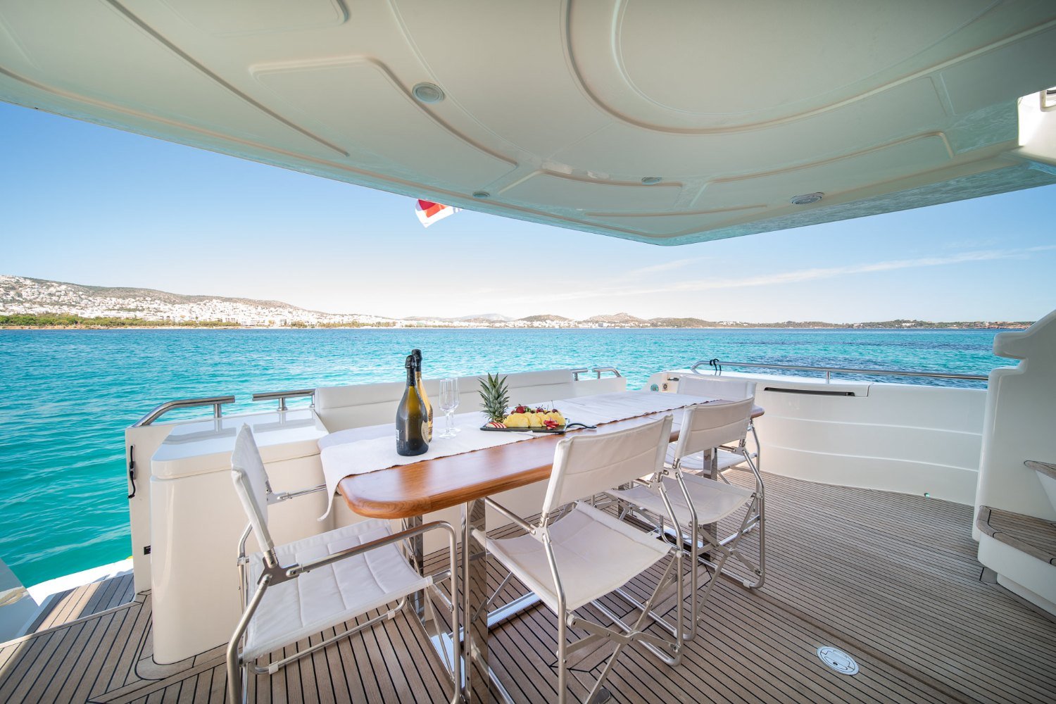 Ferretti 68 motor yacht charter Mykonos aft deck dining table