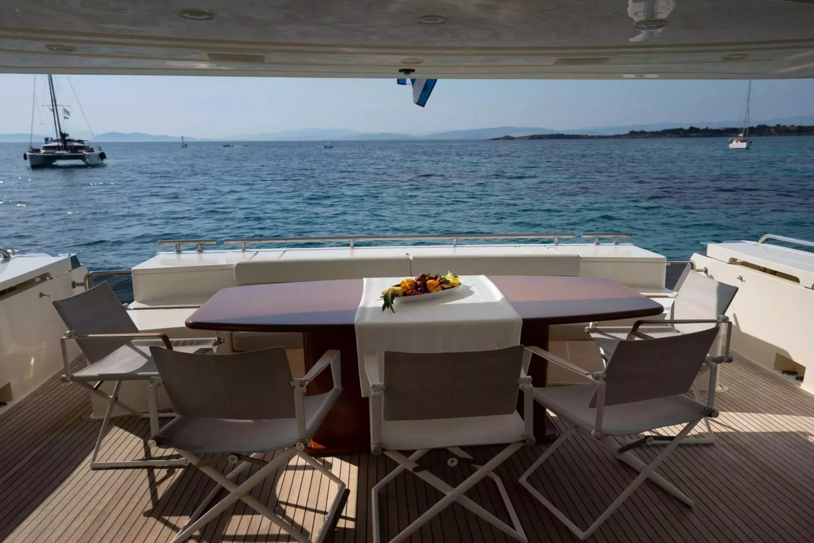Ferretti 780 motor yacht charter Athens aft deck dining table
