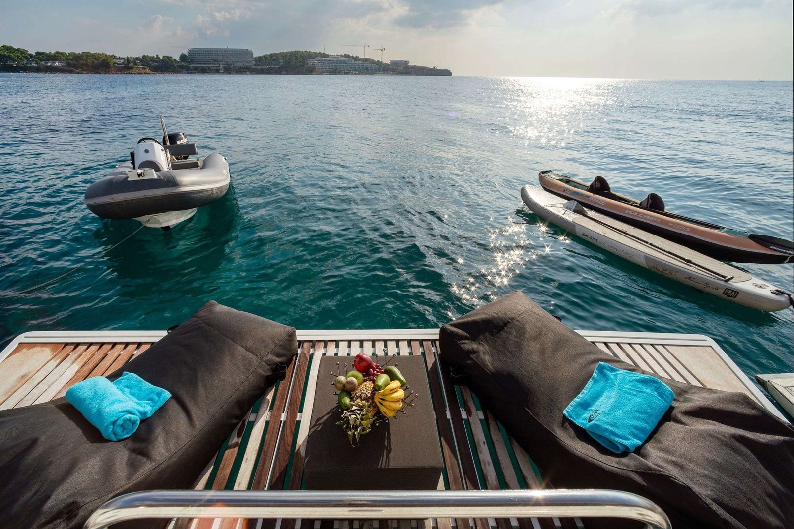 Lagoon 560 charter Athens catamaran swim platform and sunbeds with the tender alongside