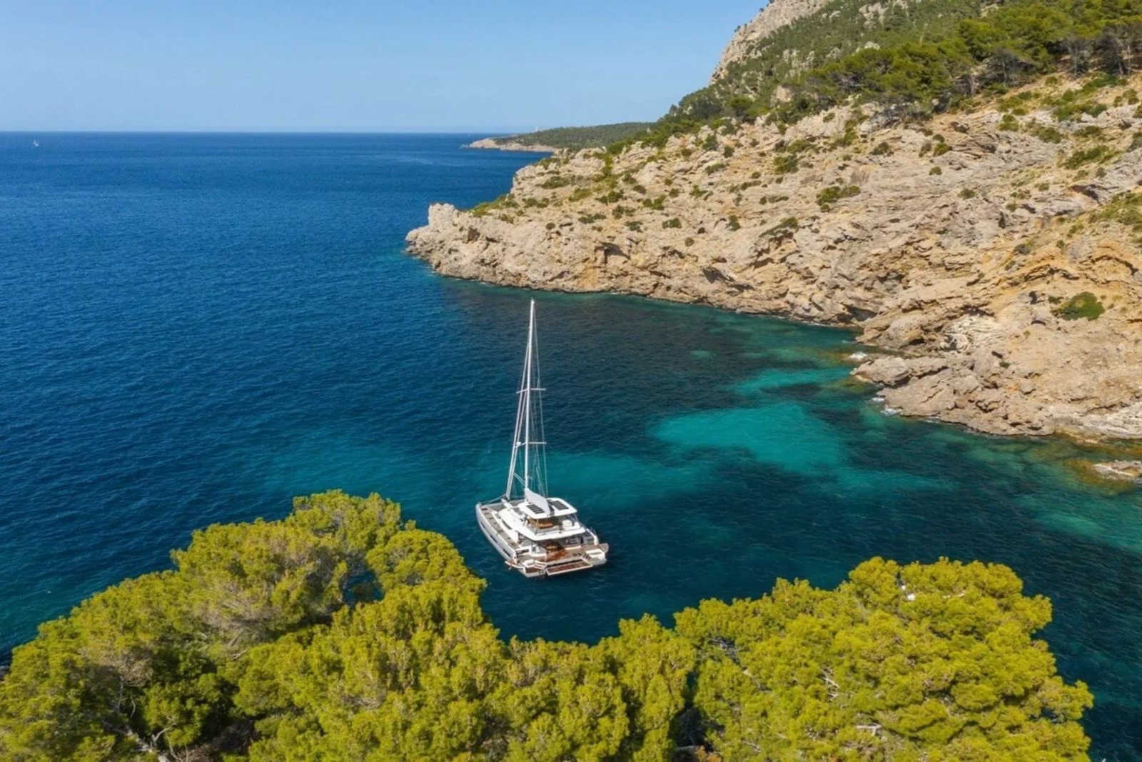 Lagoon 60 catamaran charter Athens anchored in a sheltered cove