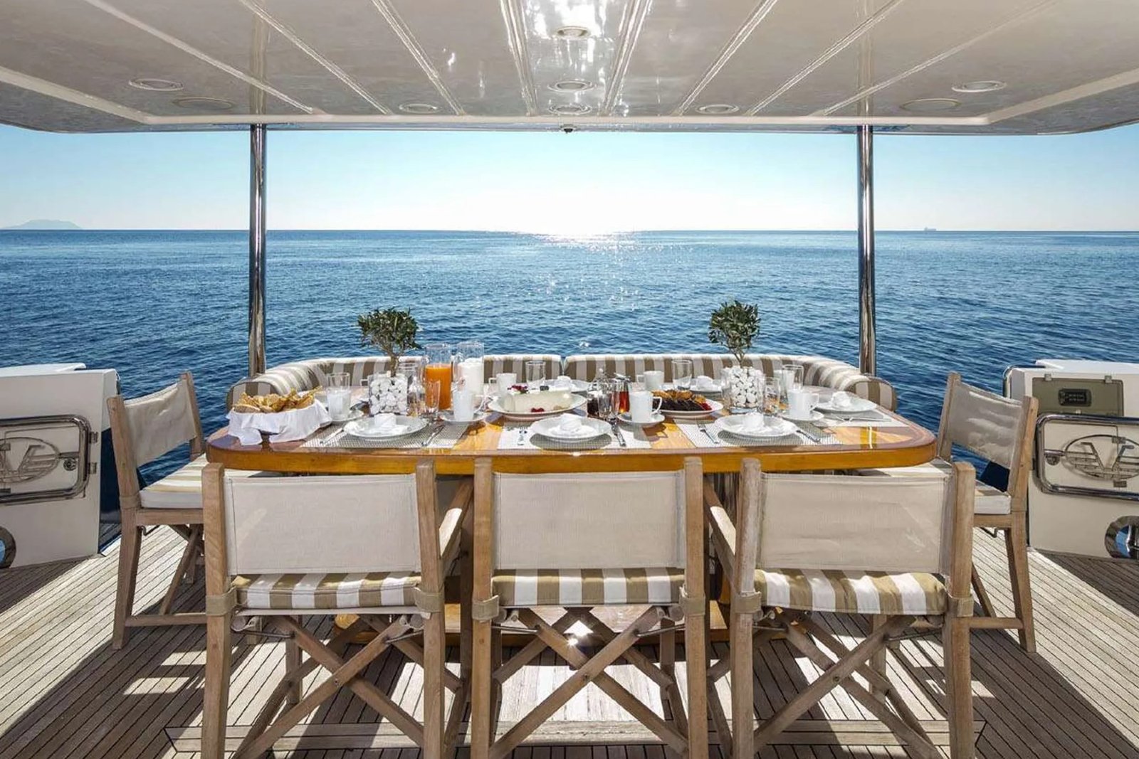 Dinner served on deck aboard a Posillipo Technema 85 motor yacht charter Athens