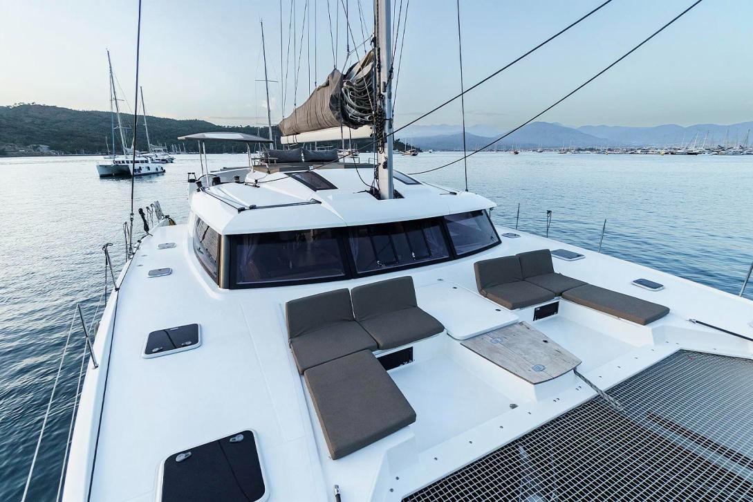 Bow sunpads on a crewed catamaran charter Fethiye with Lycian coast views