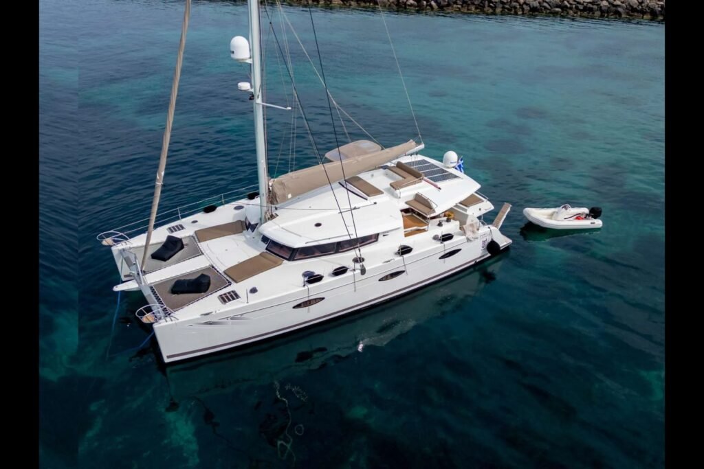 Sanya 57 catamaran charter Athens at anchor over clear water