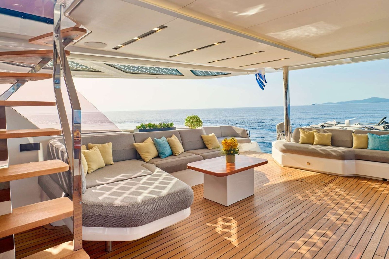 Thira 80 catamaran charter Greece flybridge lounge with sunpads and sea views